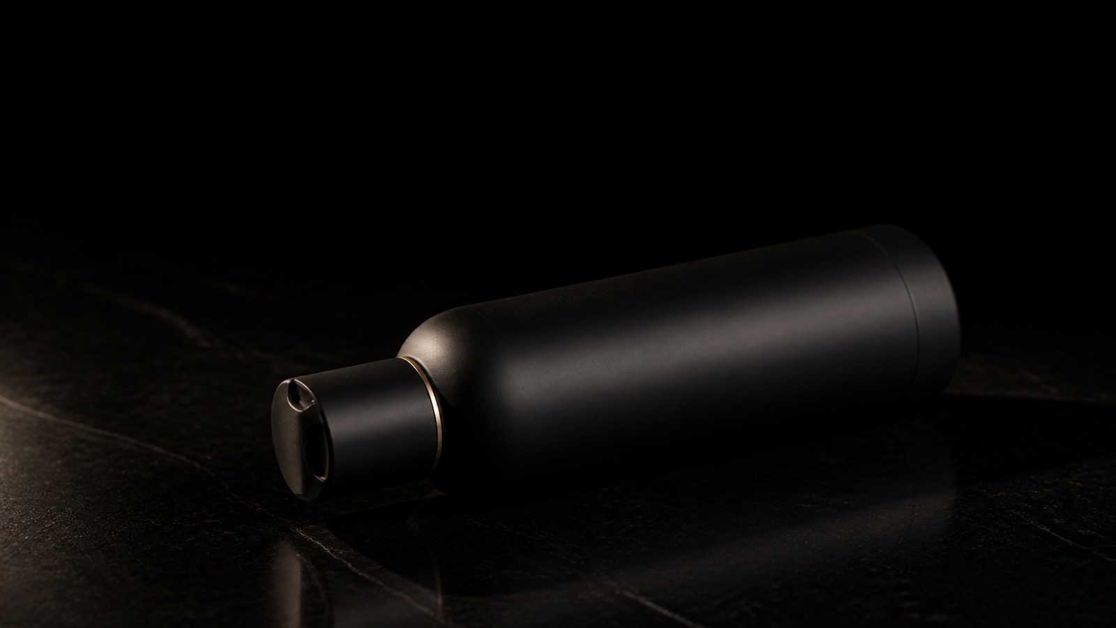 Daily Curl Conditioner — seen in three-quarter view, low in a wide frame — under a single warm gold light on black.
