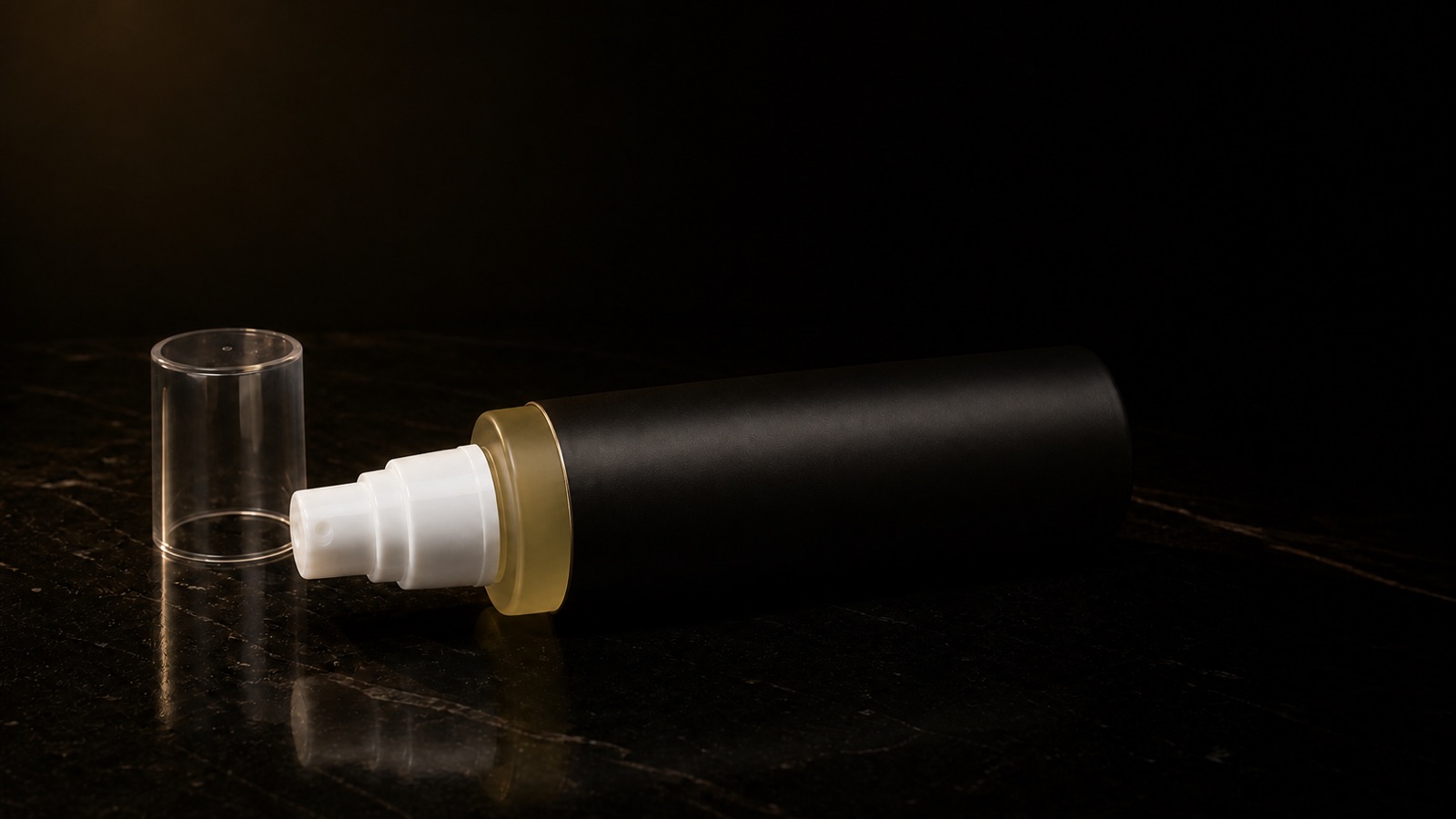 Cleansing Oil — seen in three-quarter view, low in a wide frame — under a single warm gold light on black.