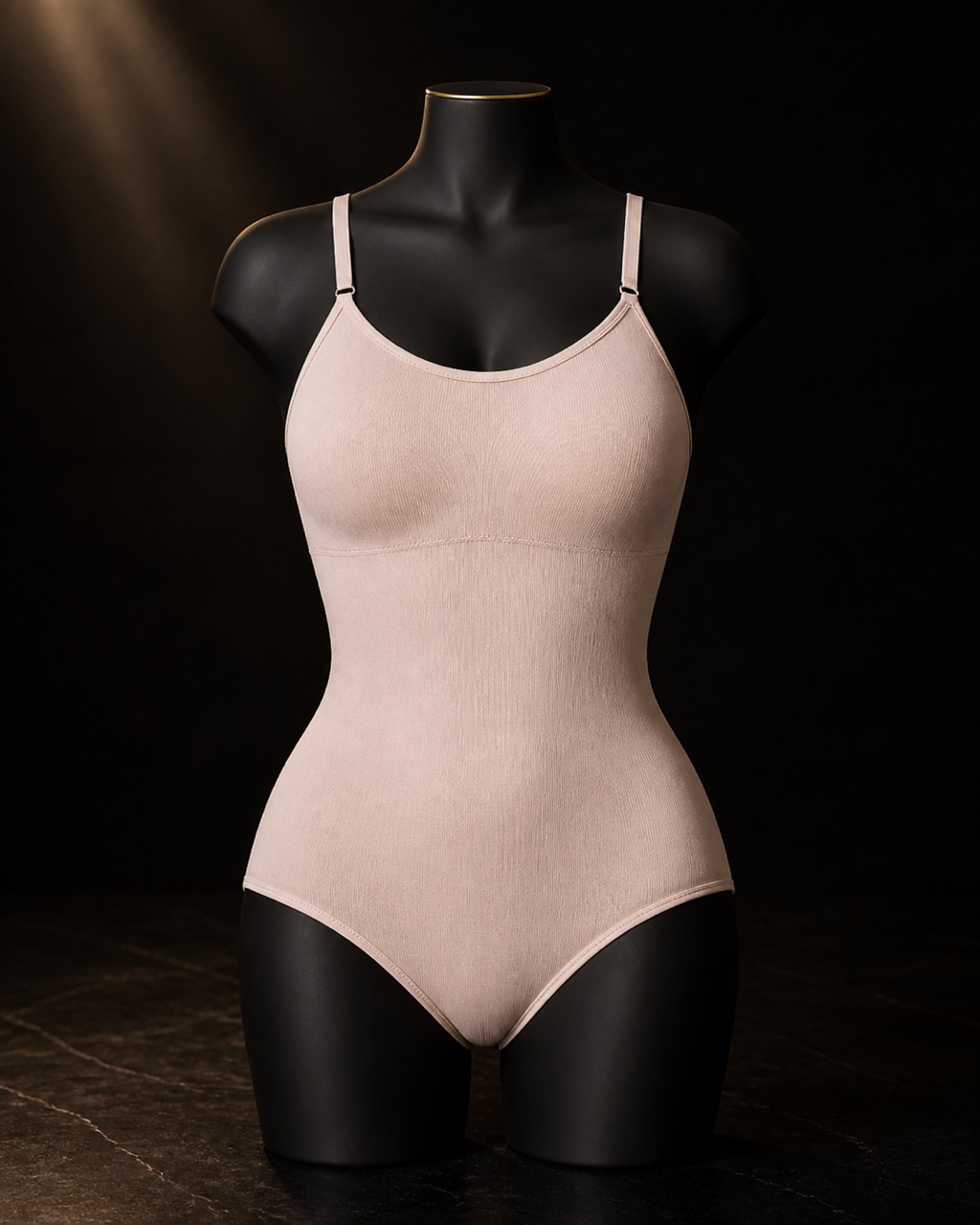 Scoop-Neck Shaping Bodysuit — scoop-neck shaping bodysuit — standing alone against near-black under a single warm gold light.