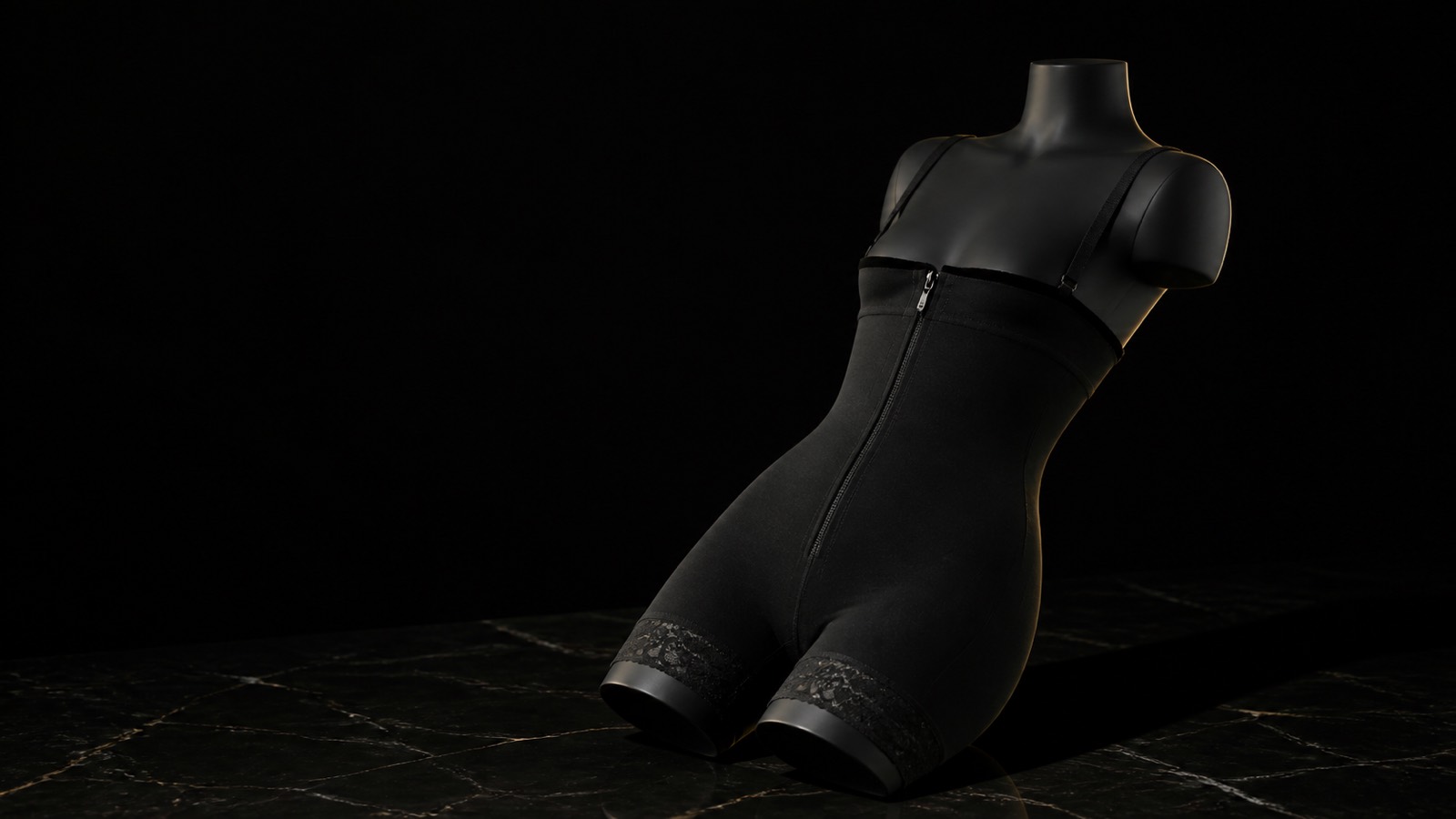Under-Bust Zip Bodysuit — seen in three-quarter view, low in a wide frame — under a single warm gold light on black.