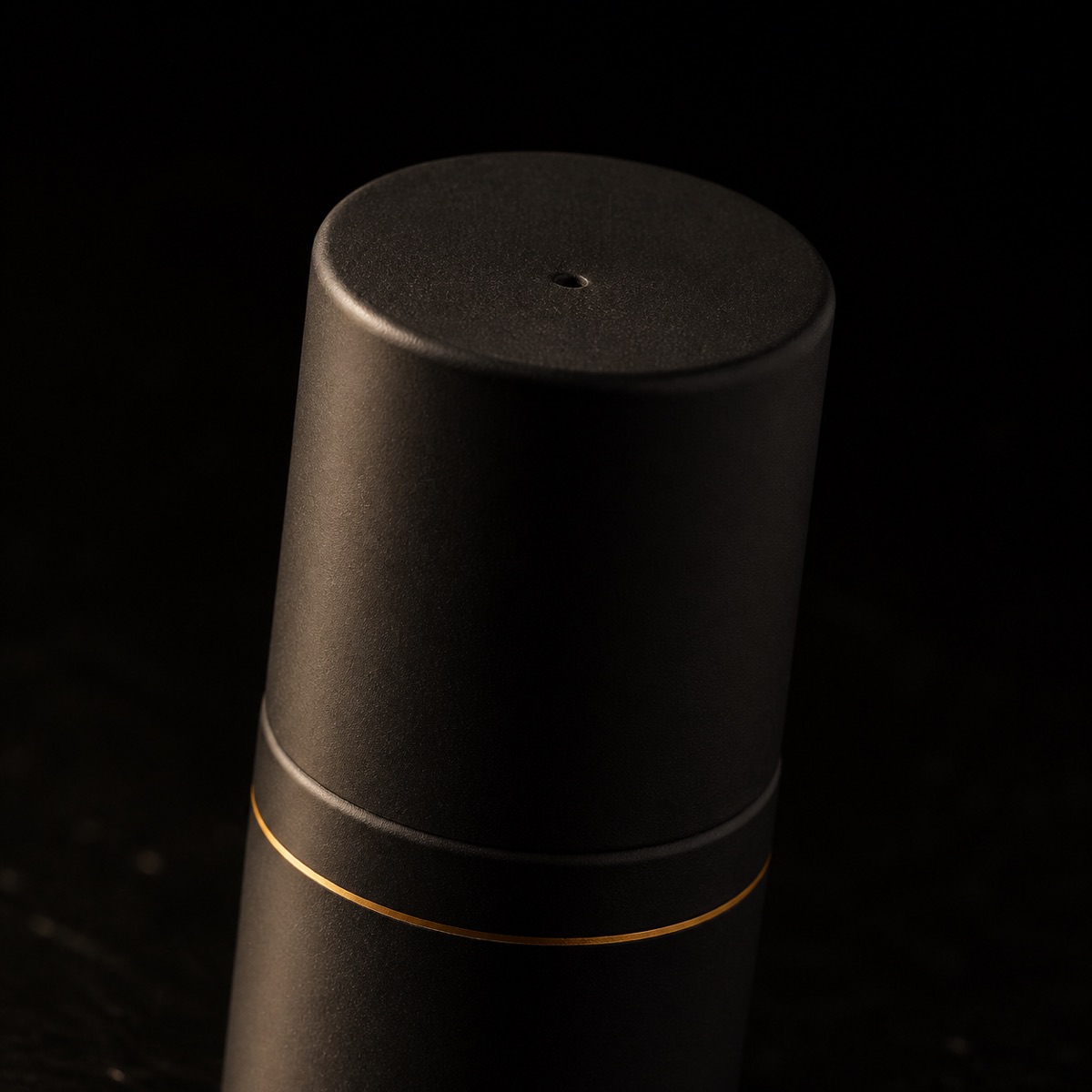 Hydro Balancing Gel-Cream — the working end at magnification — under a single warm gold light on black.