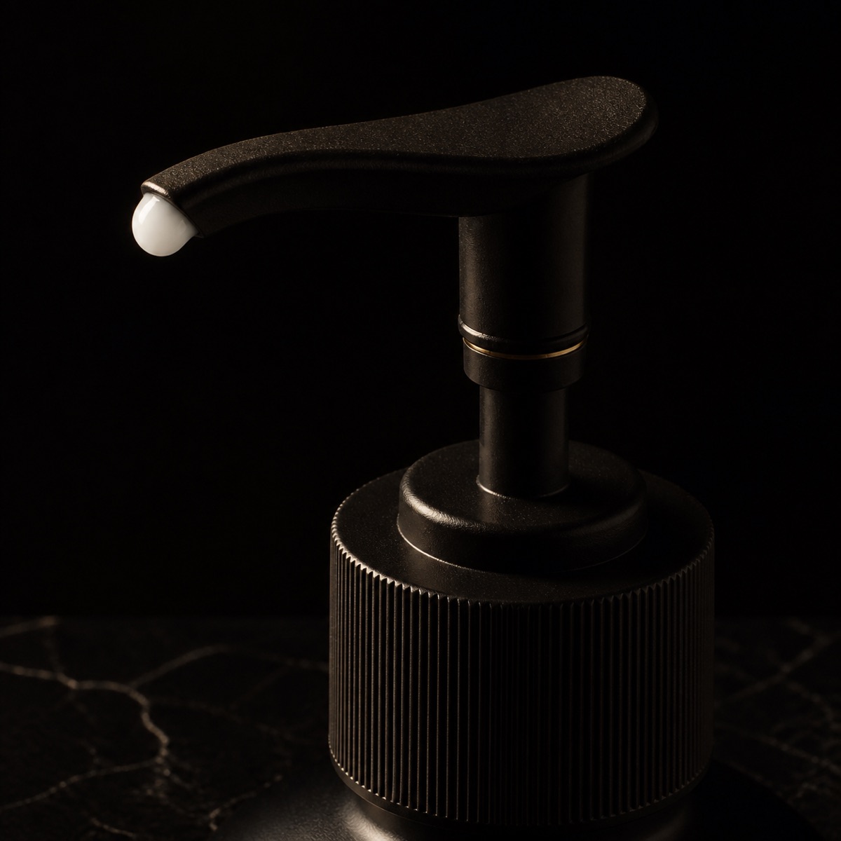 Makeup Remover Lotion — the working end at magnification — under a single warm gold light on black.