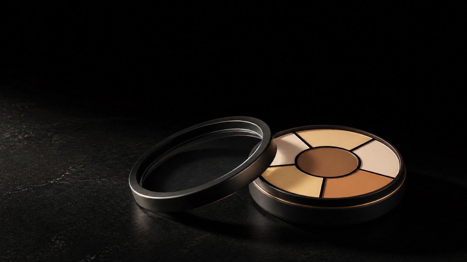 Corrector Wheel — Deep — seen in three-quarter view, low in a wide frame — under a single warm gold light on black.