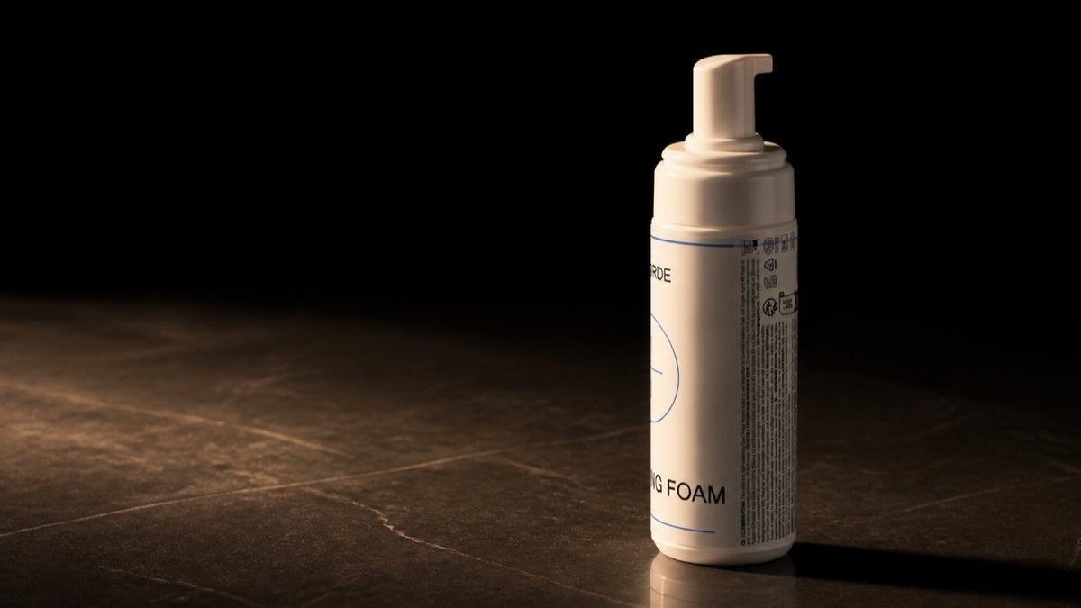 Cleansing Foam. The bottle seen from the side, low in the wide frame.