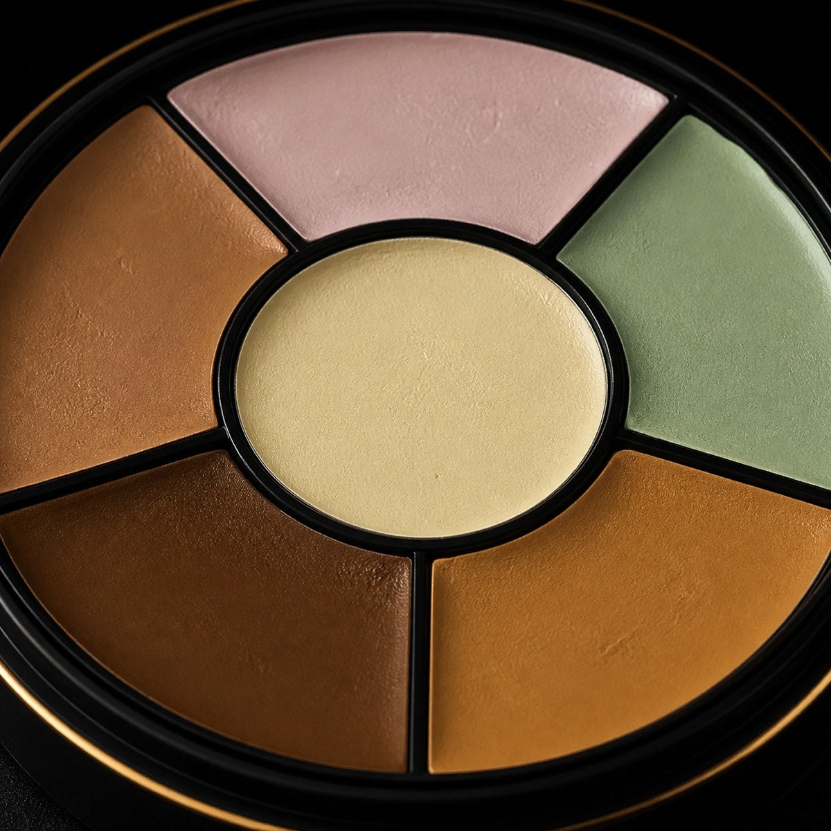 Corrector Wheel — Six Tones — the working end at magnification — under a single warm gold light on black.