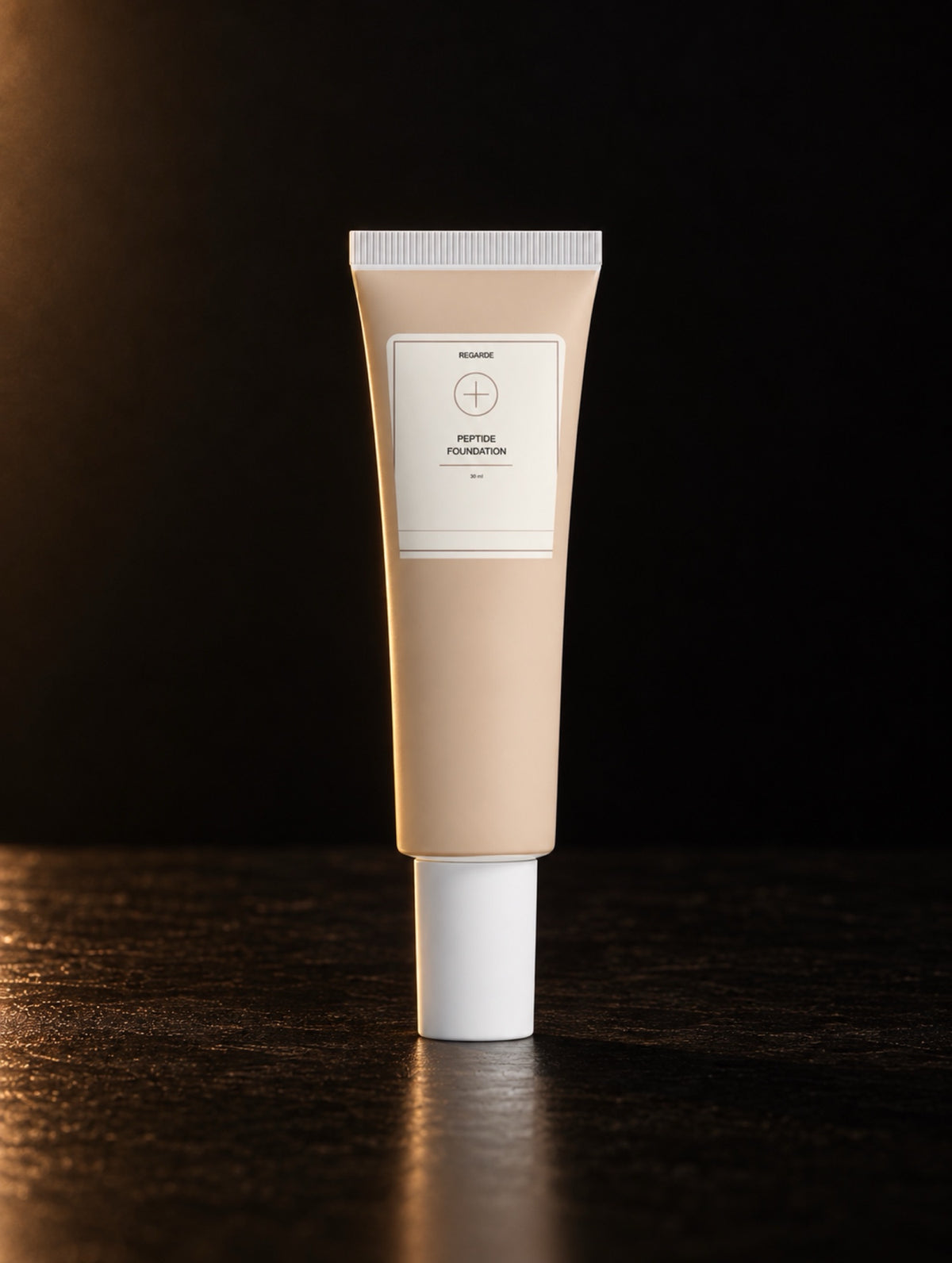 Peptide Foundation — 05 Fair Neutral, digitally styled tube on black stone in warm side light.