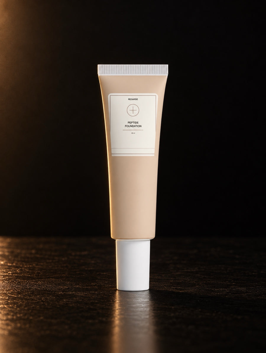 Peptide Foundation — 05 Fair Neutral, digitally styled tube on black stone in warm side light.