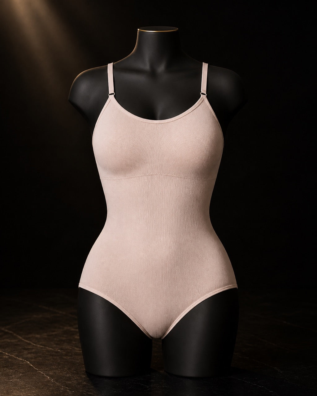 Scoop-Neck Shaping Bodysuit — standing alone, complete — under a single warm gold light on black.