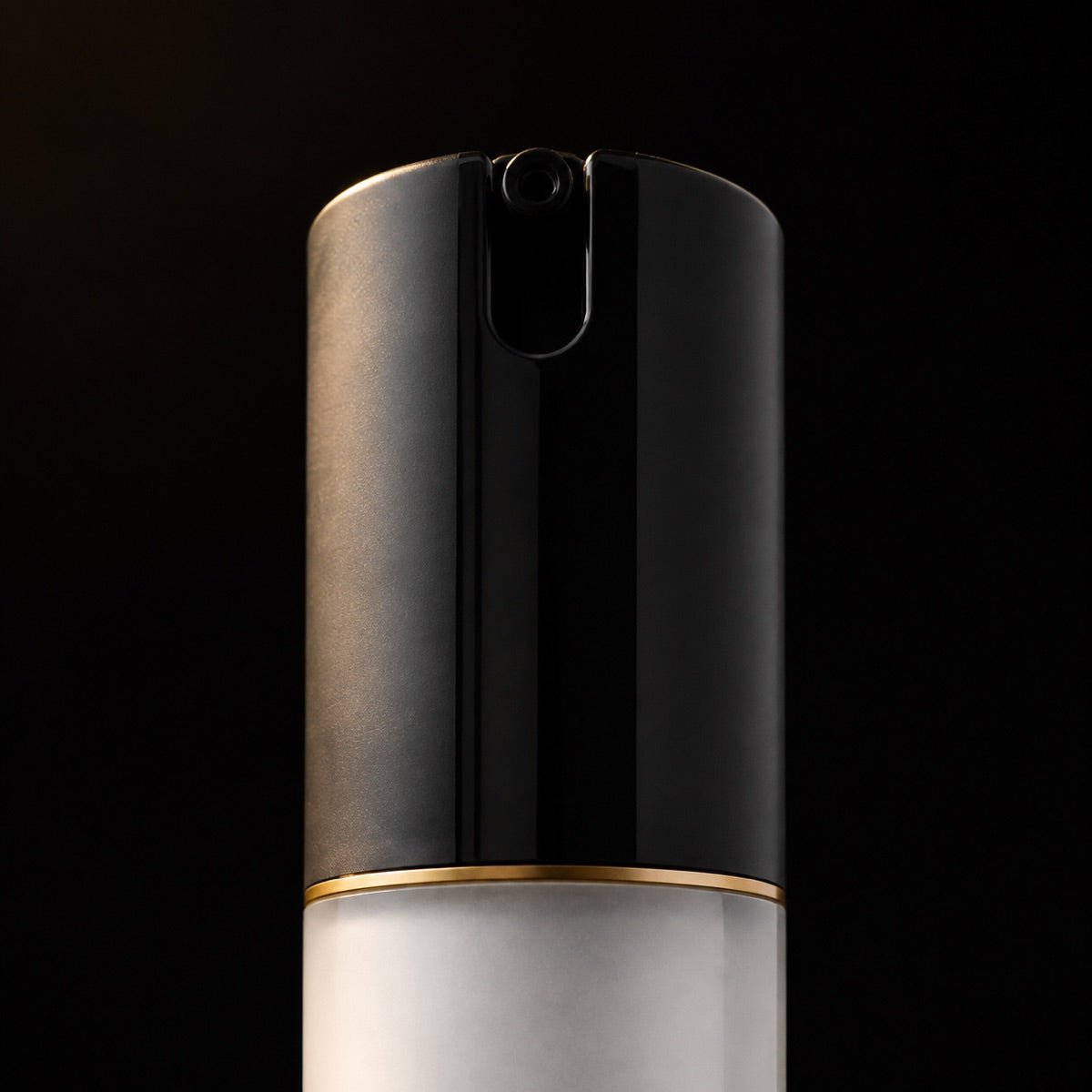 Soothing Moisturizer — the working end at magnification — under a single warm gold light on black.